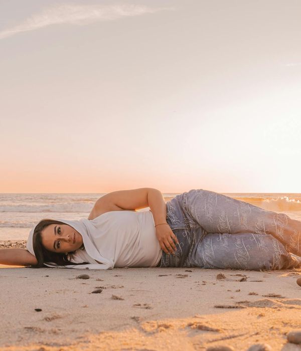 Person meditating peacefully outdoors with soft sunlight.